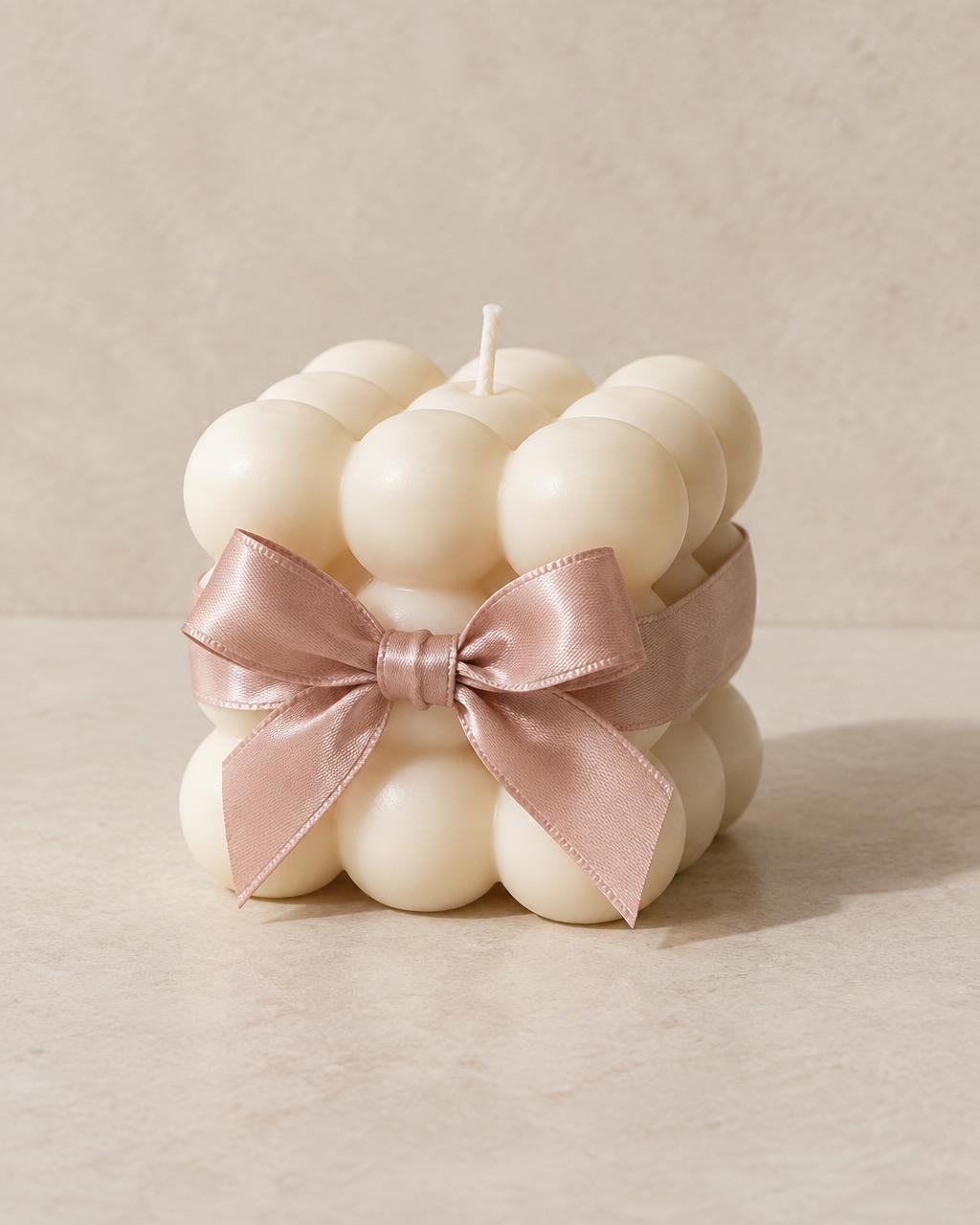 Rose Reverie sample bubble candle with its signature blush satin ribbon